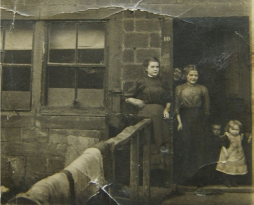 Luty Family outside one of Club Row houses.