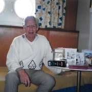 John Tonks. At sea, In the cabin with birthday cards & presents